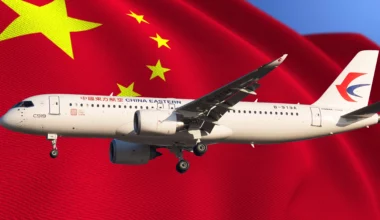a plane flying in front of a Chinese flag