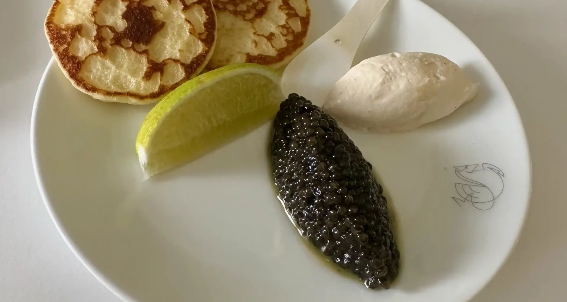 a plate of food with a lime wedge and a spoon