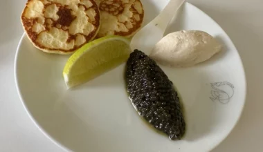 a plate of food with a lime wedge and a spoon