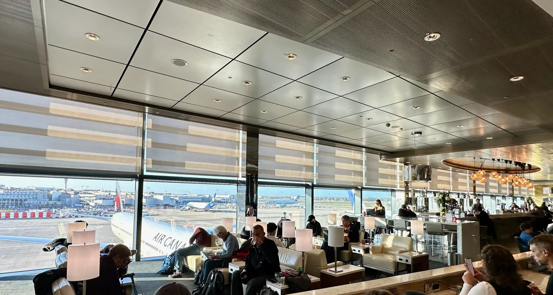 people sitting in a room with a large window