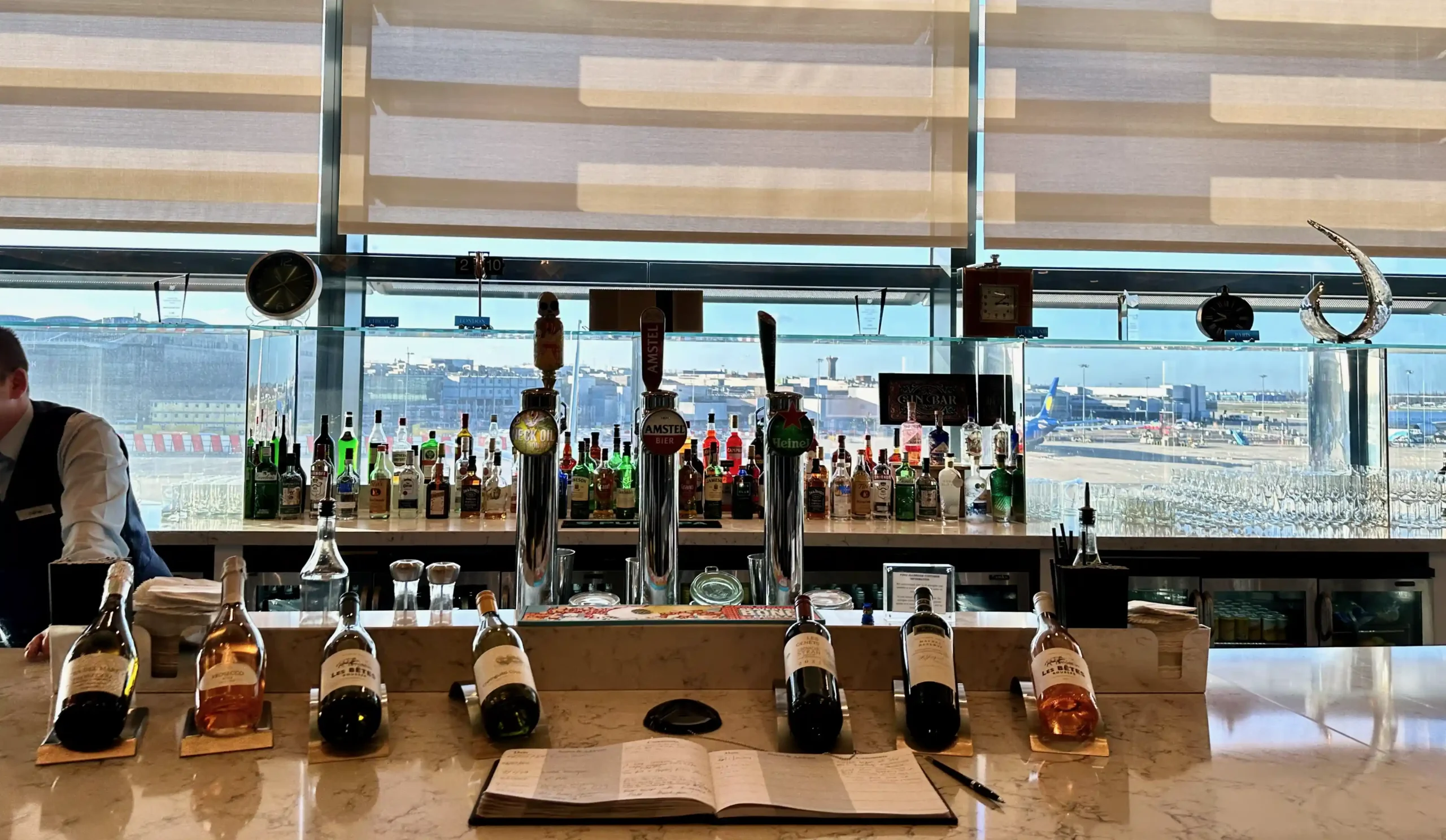 a bar with bottles of alcohol on the counter