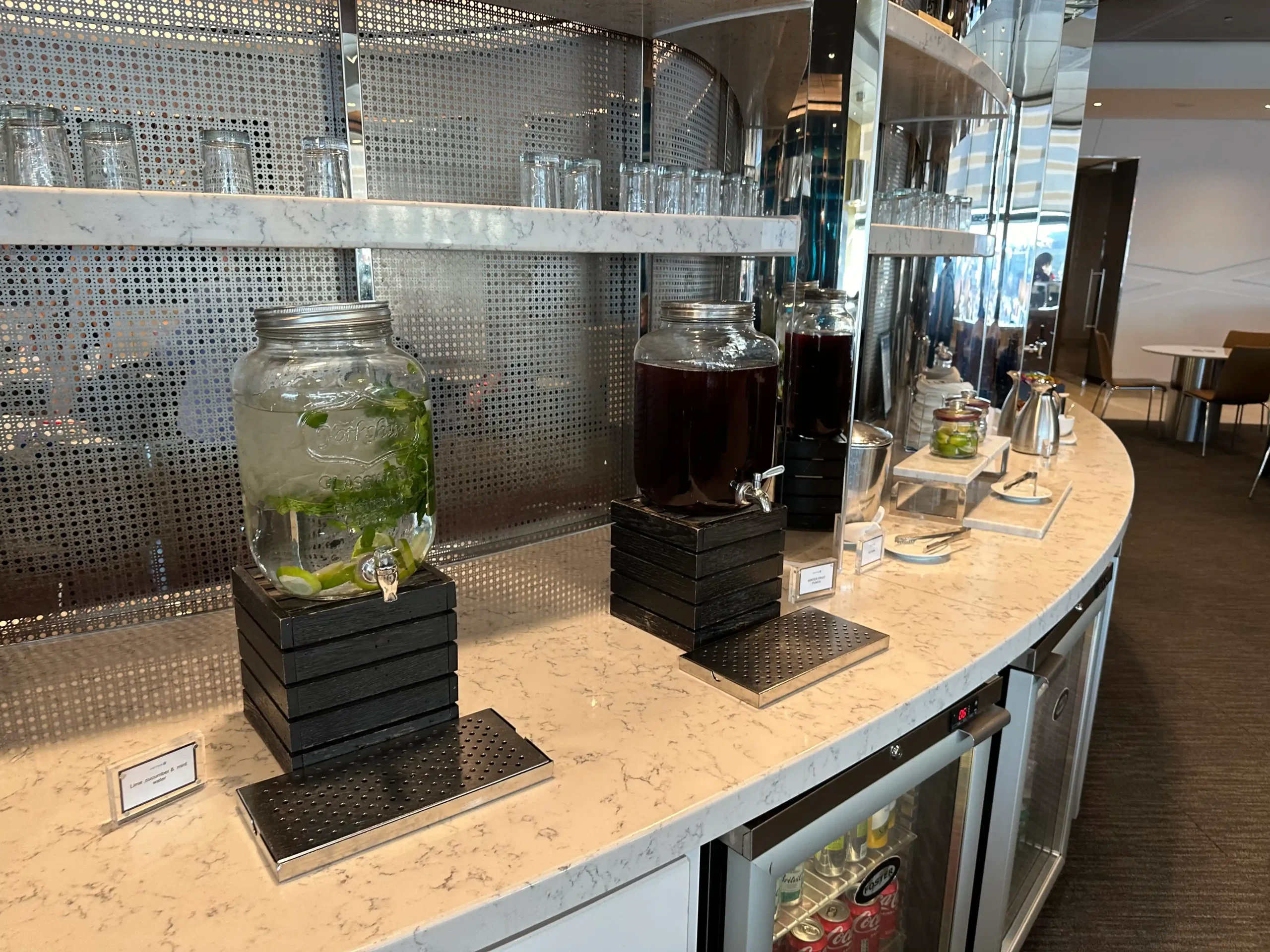 a counter with a few jars of liquid and glasses