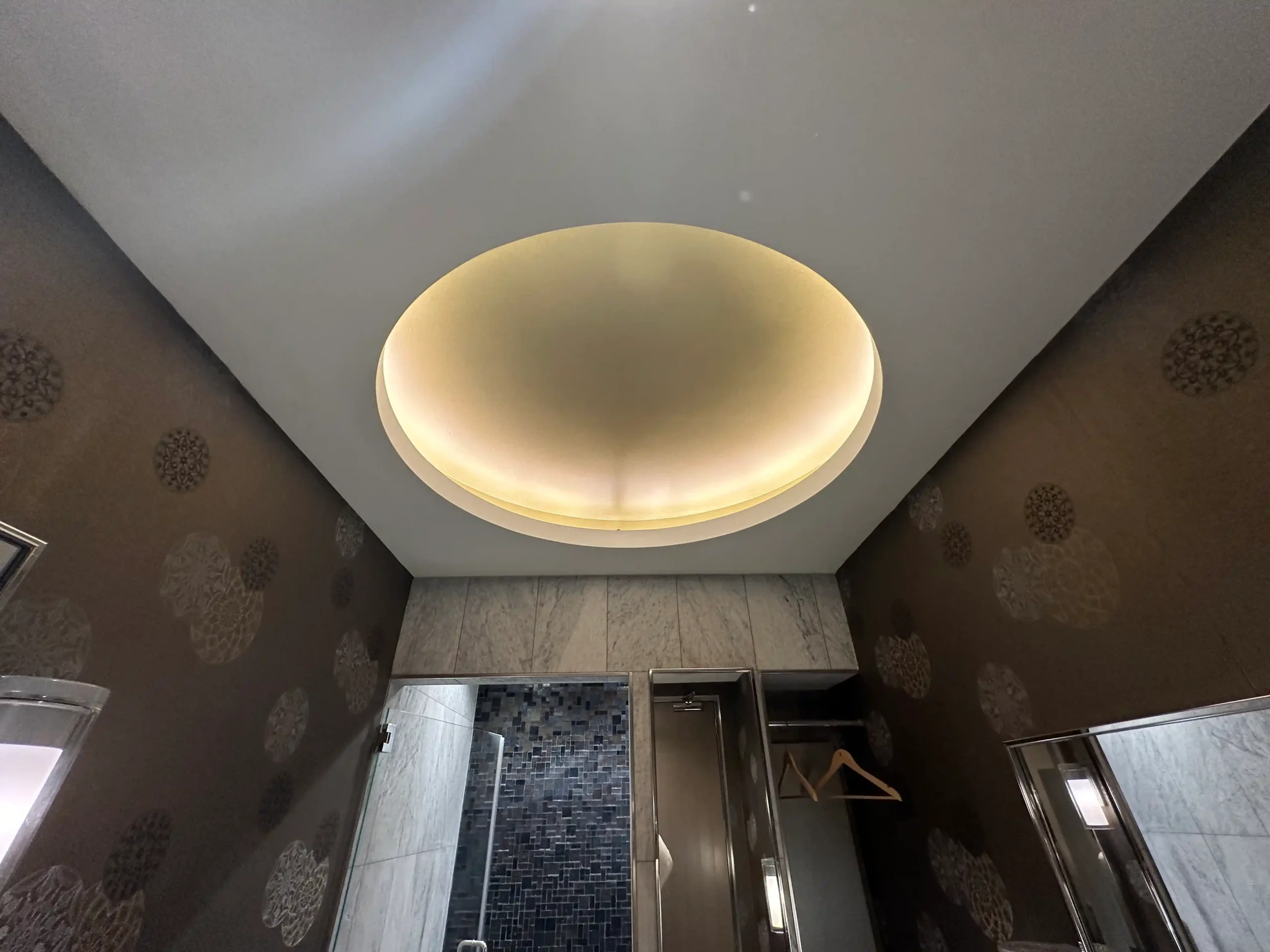 a bathroom with a round light fixture