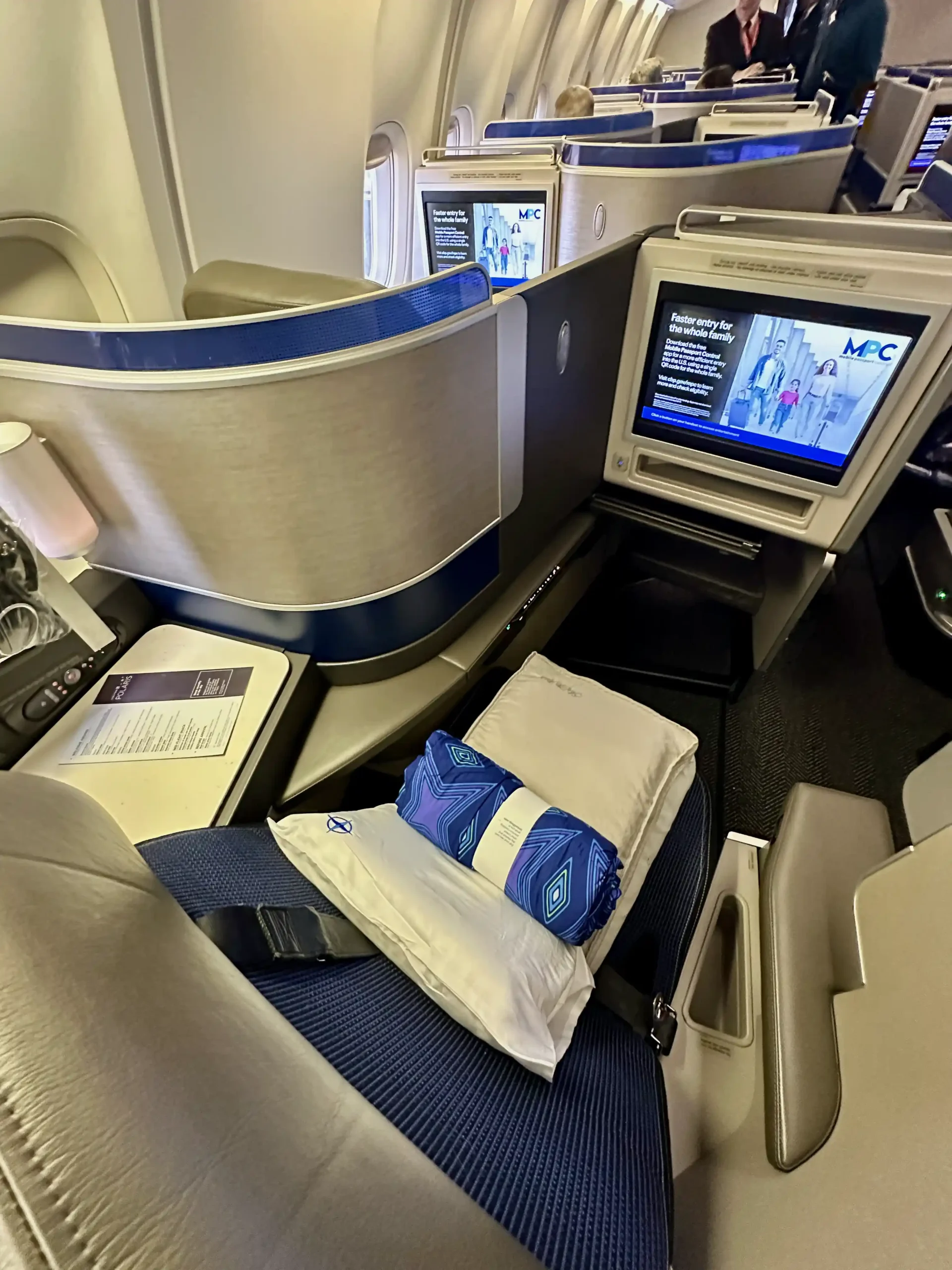 a seat with a pillow and a monitor in the middle of the seat