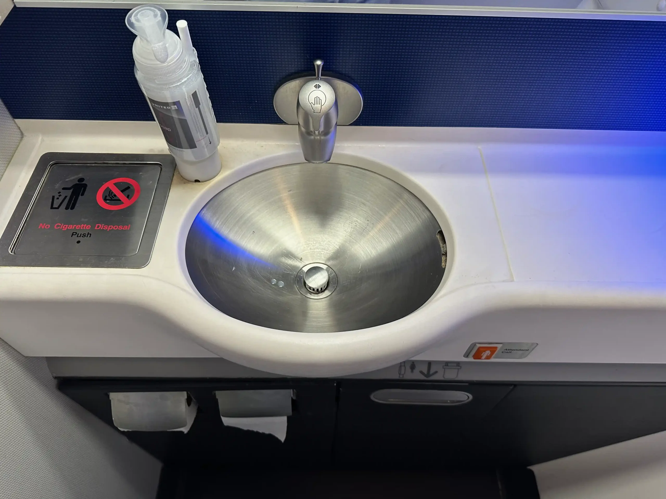 a sink with a bottle of soap and a bottle of liquid