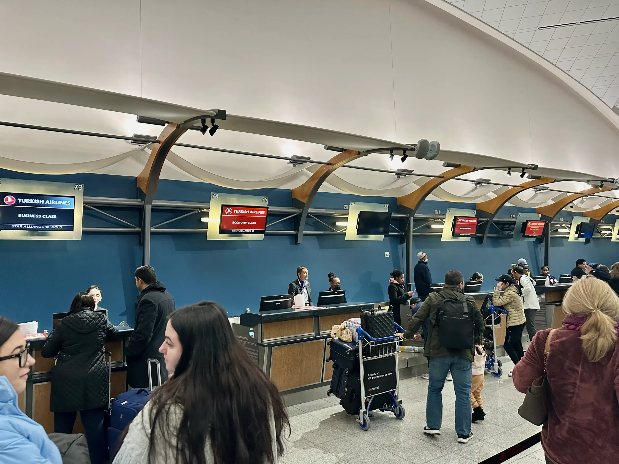 people standing in a line at an airport