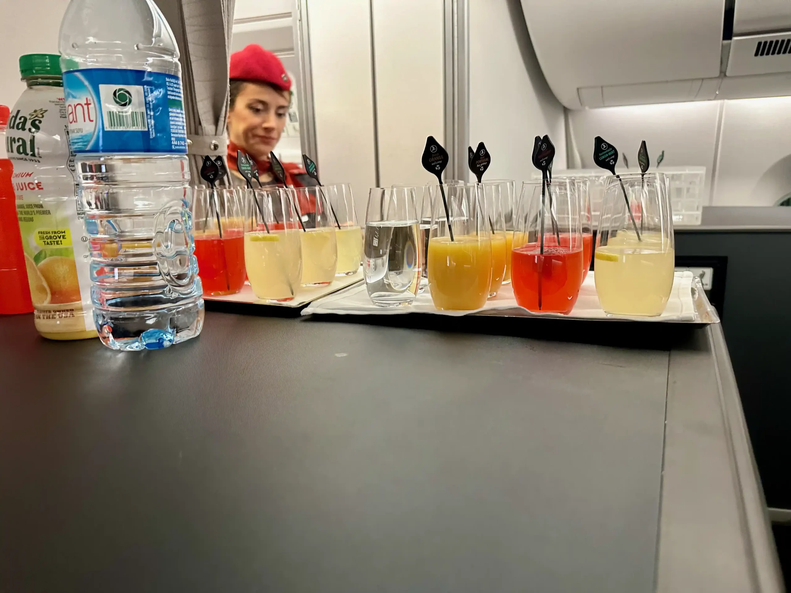 a row of glasses with different colored drinks