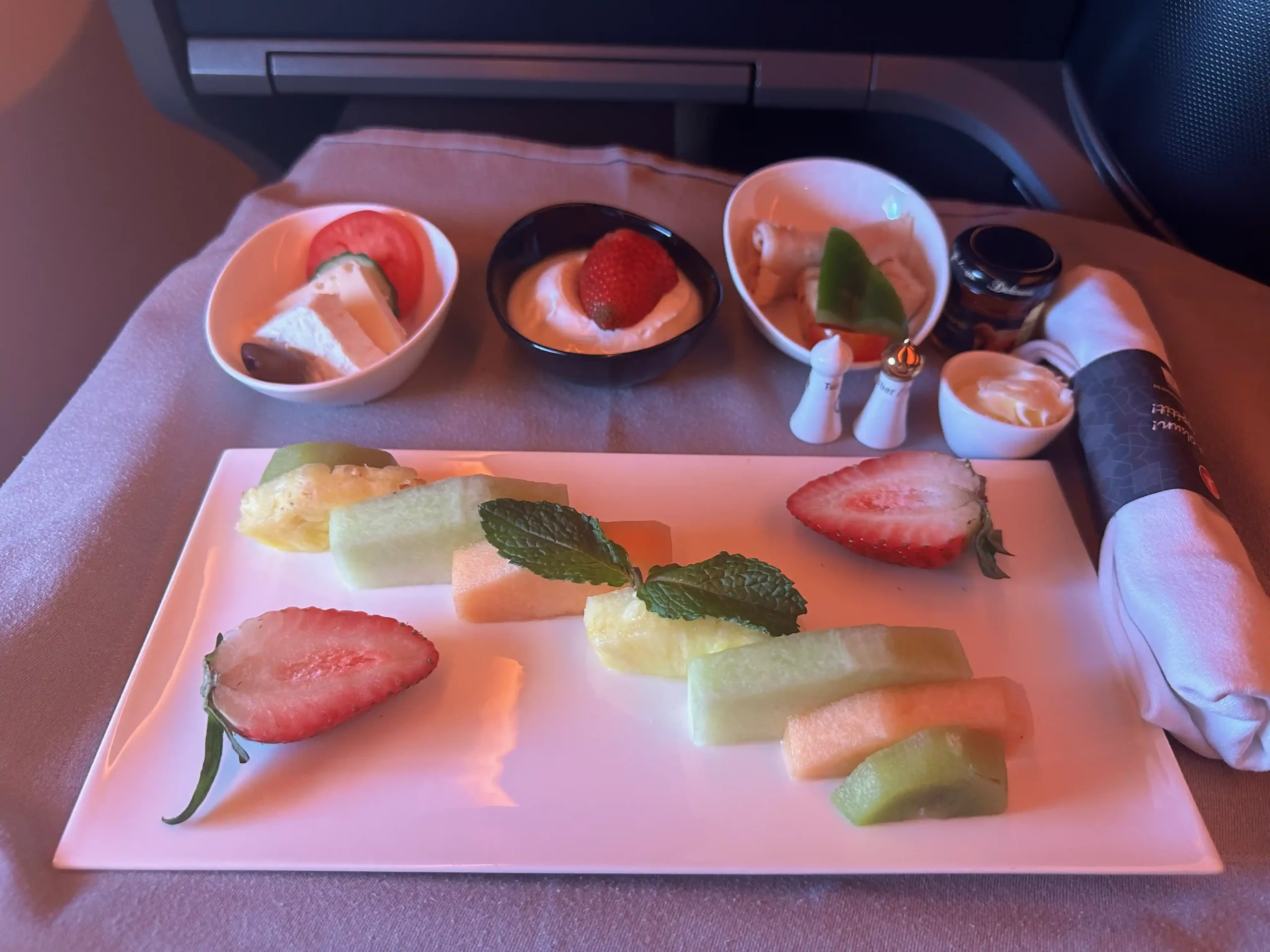 a plate of fruit and desserts on a tray