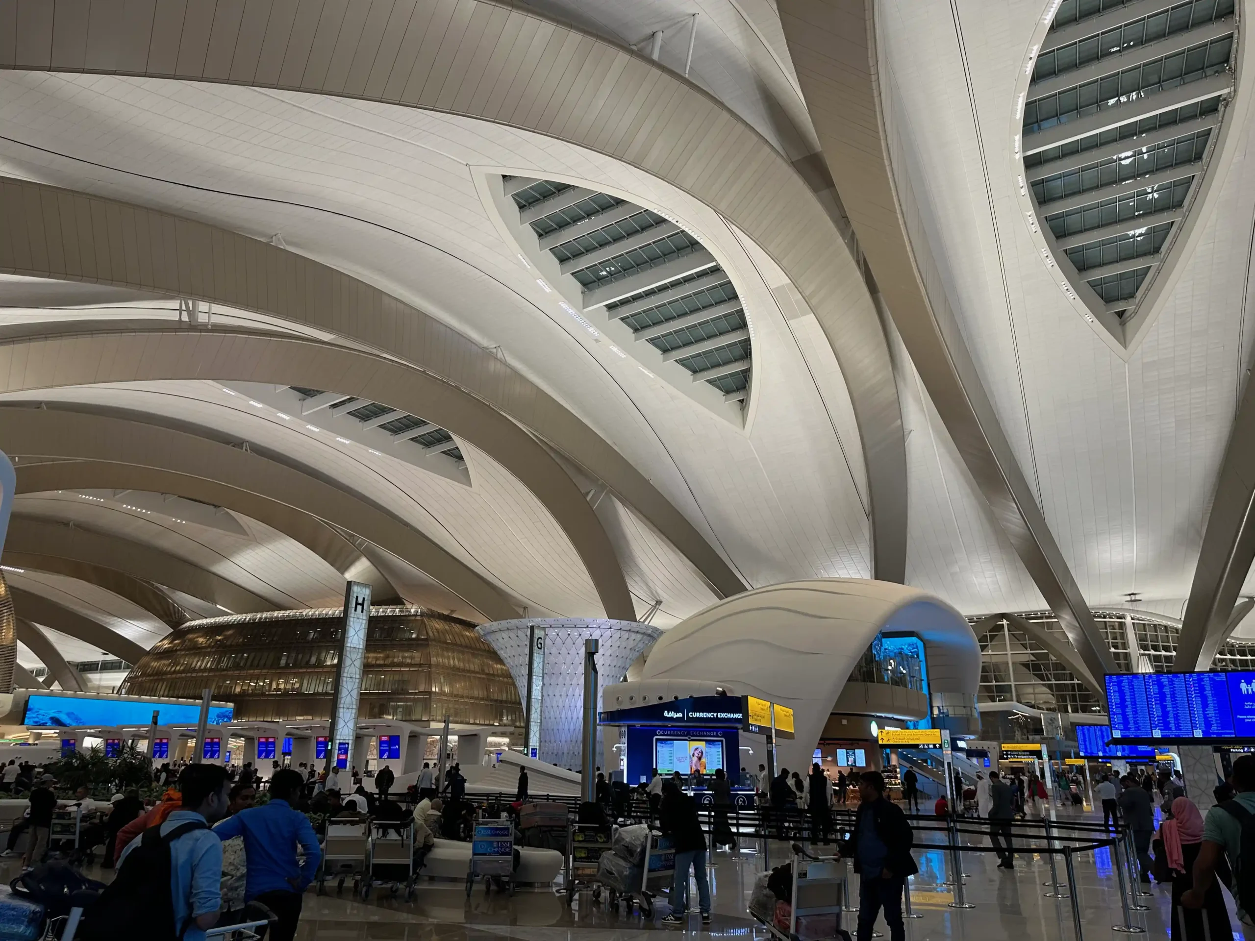 a large white building with many people