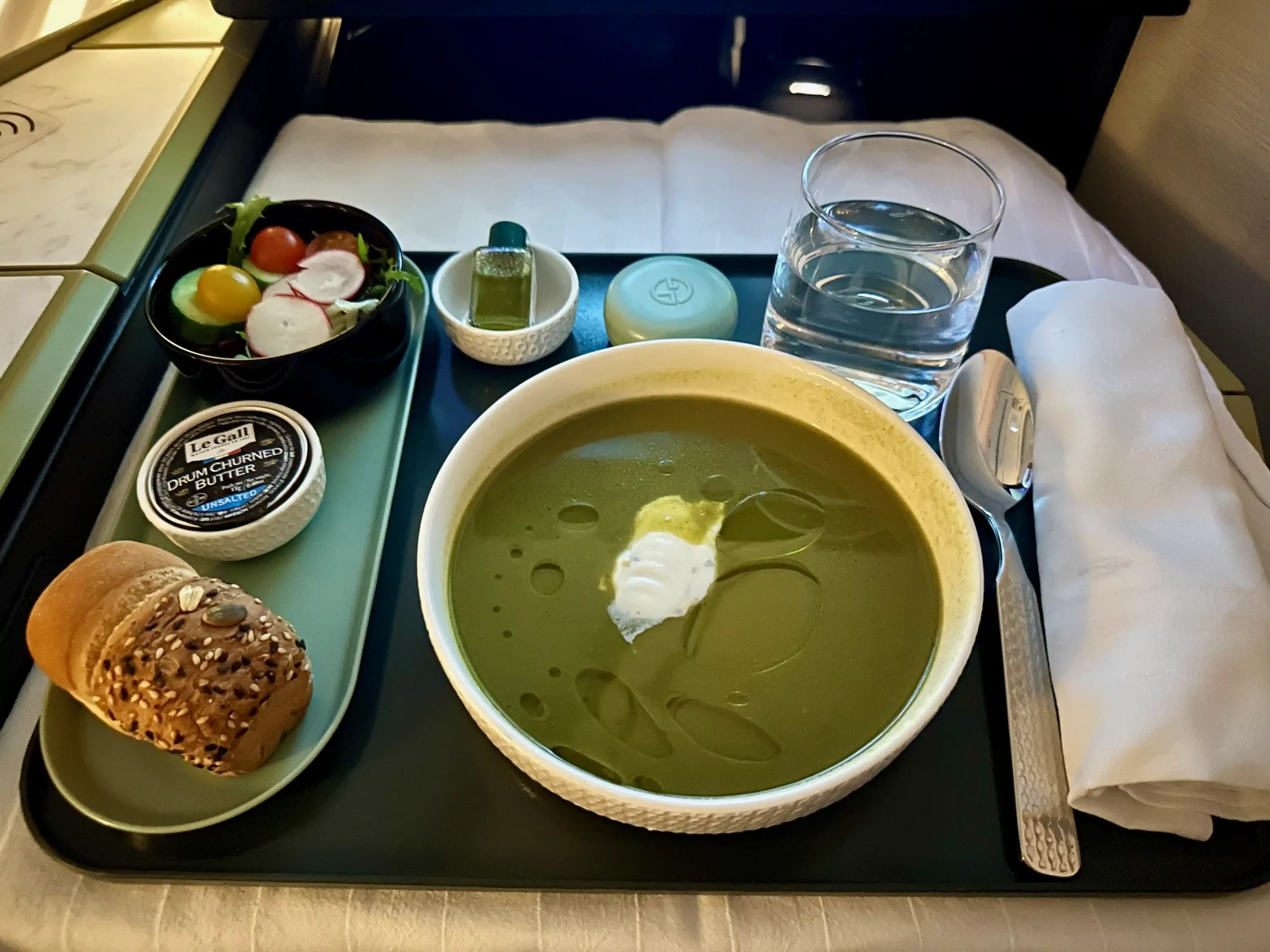 a tray with food and a glass of water