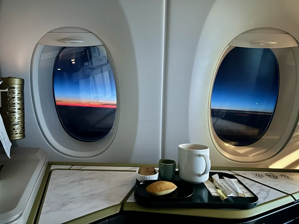 a tray with food and a cup on it in an airplane